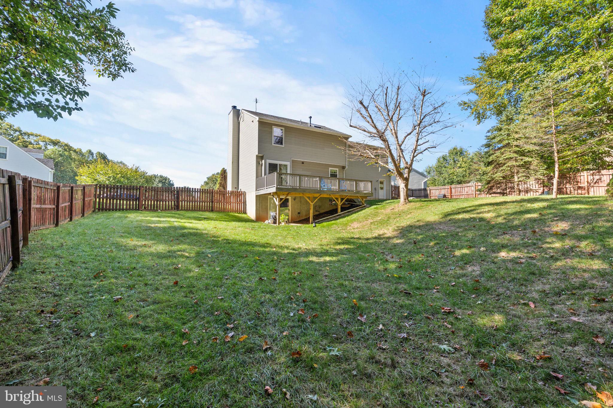 13911 Ruler Court Woodbridge, VA 22193 - Photo 29 of 38 a view of a house with a big yard and large trees