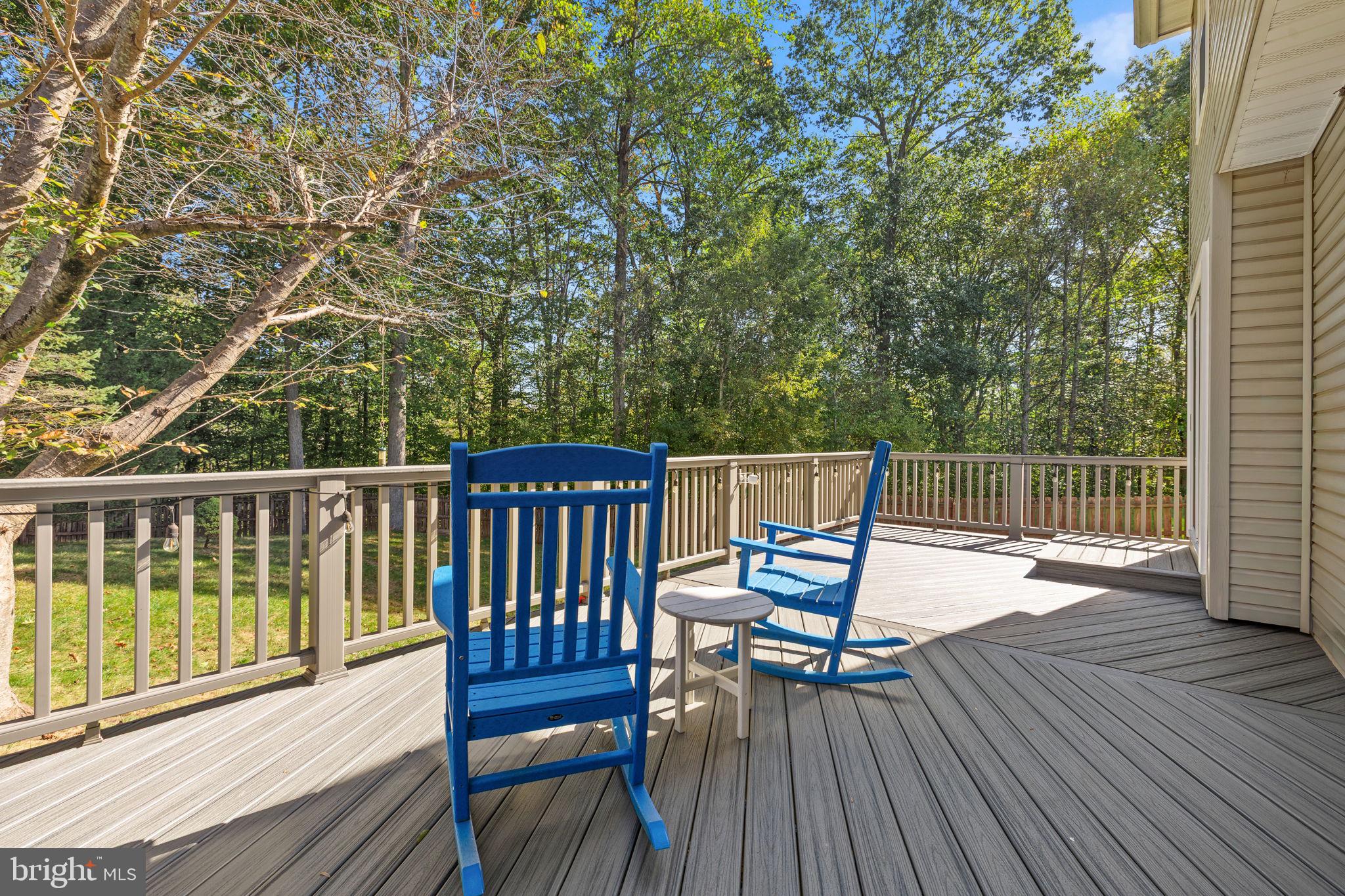 13911 Ruler Court Woodbridge, VA 22193 - Photo 32 of 38 a view of a deck with two chairs and wooden floor