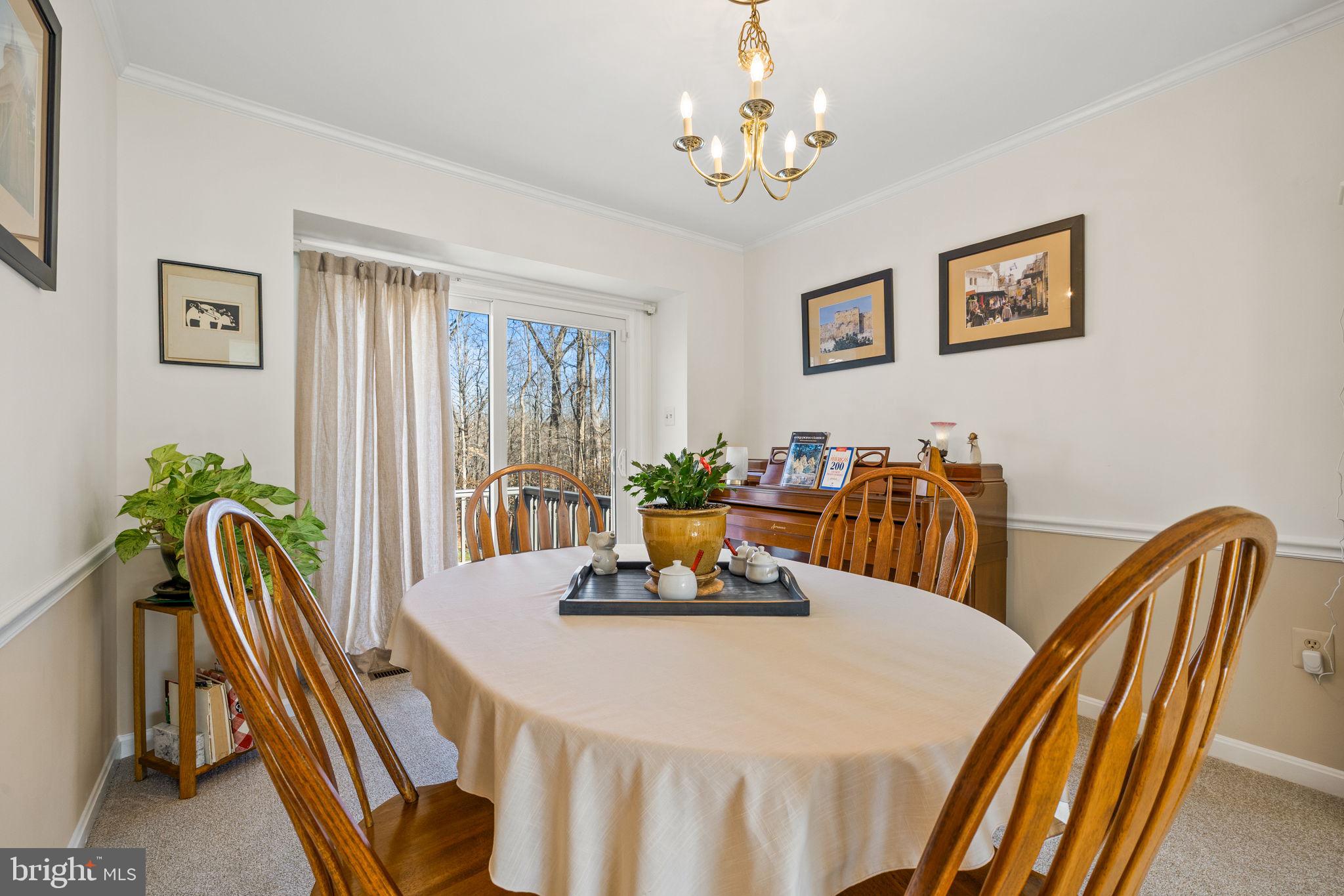 13911 Ruler Court Woodbridge, VA 22193 - Photo 8 of 38 a view of a dining room with furniture window and wooden floor