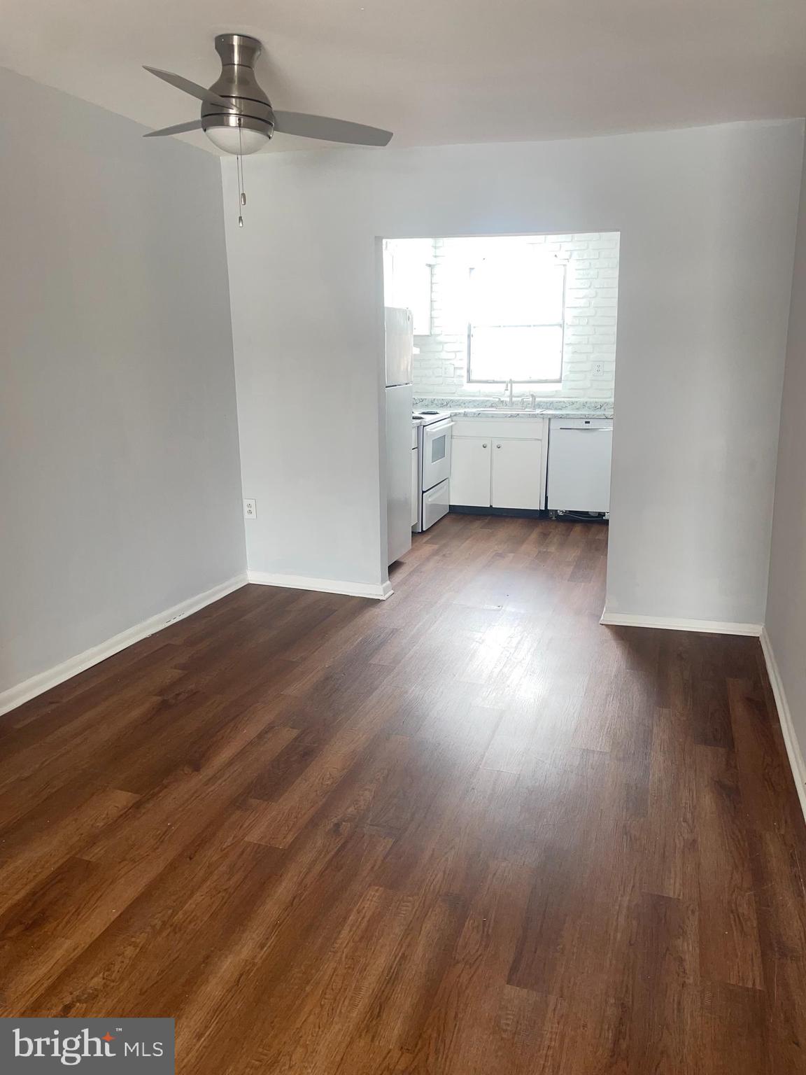 1294 Cooper Street, Unit A10 Edgewater Park, NJ 08010 - Photo 11 of 22 an empty room with wooden floor and windows