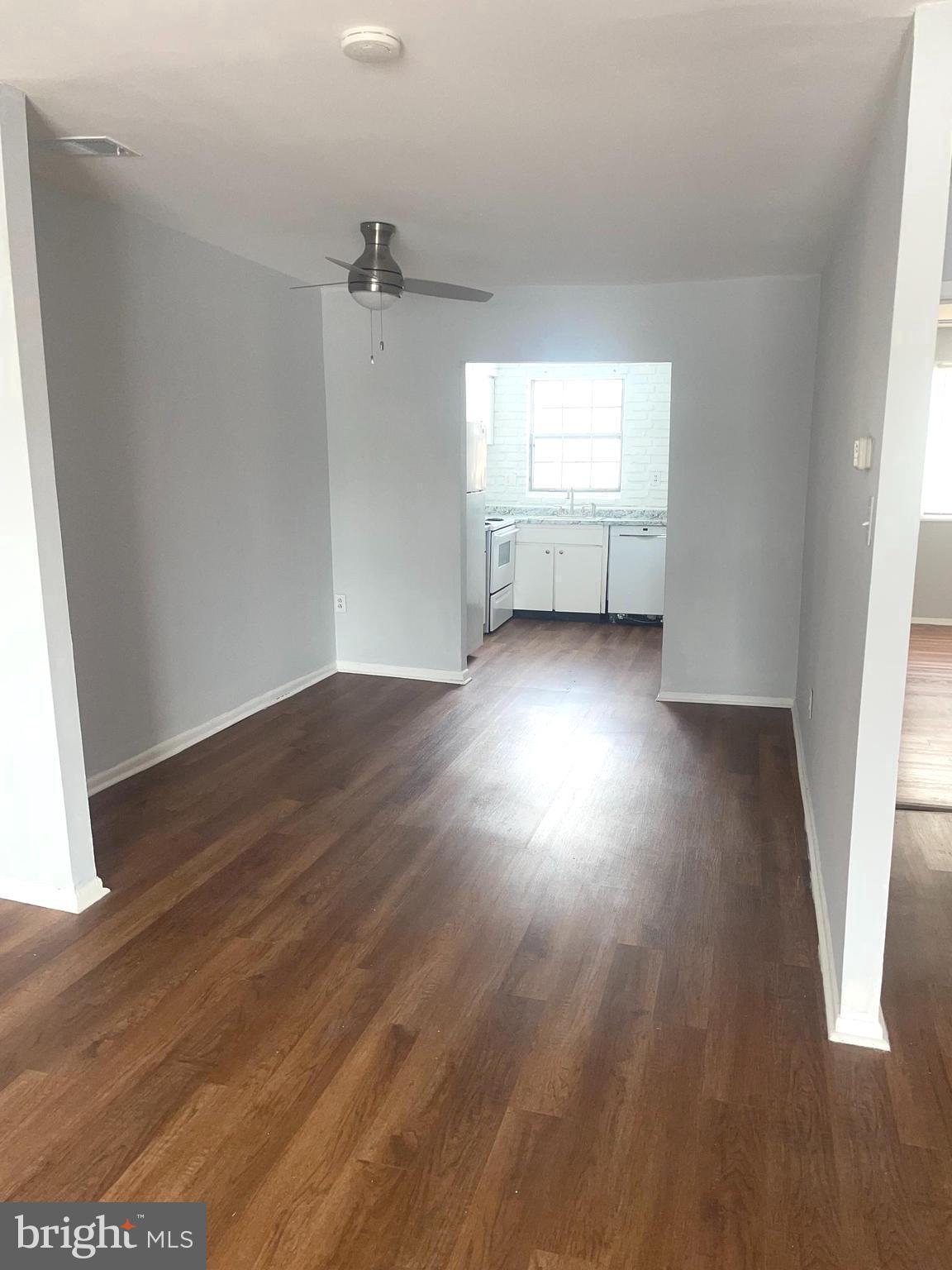 1294 Cooper Street, Unit A10 Edgewater Park, NJ 08010 - Photo 12 of 22 an empty room with wooden floor and windows