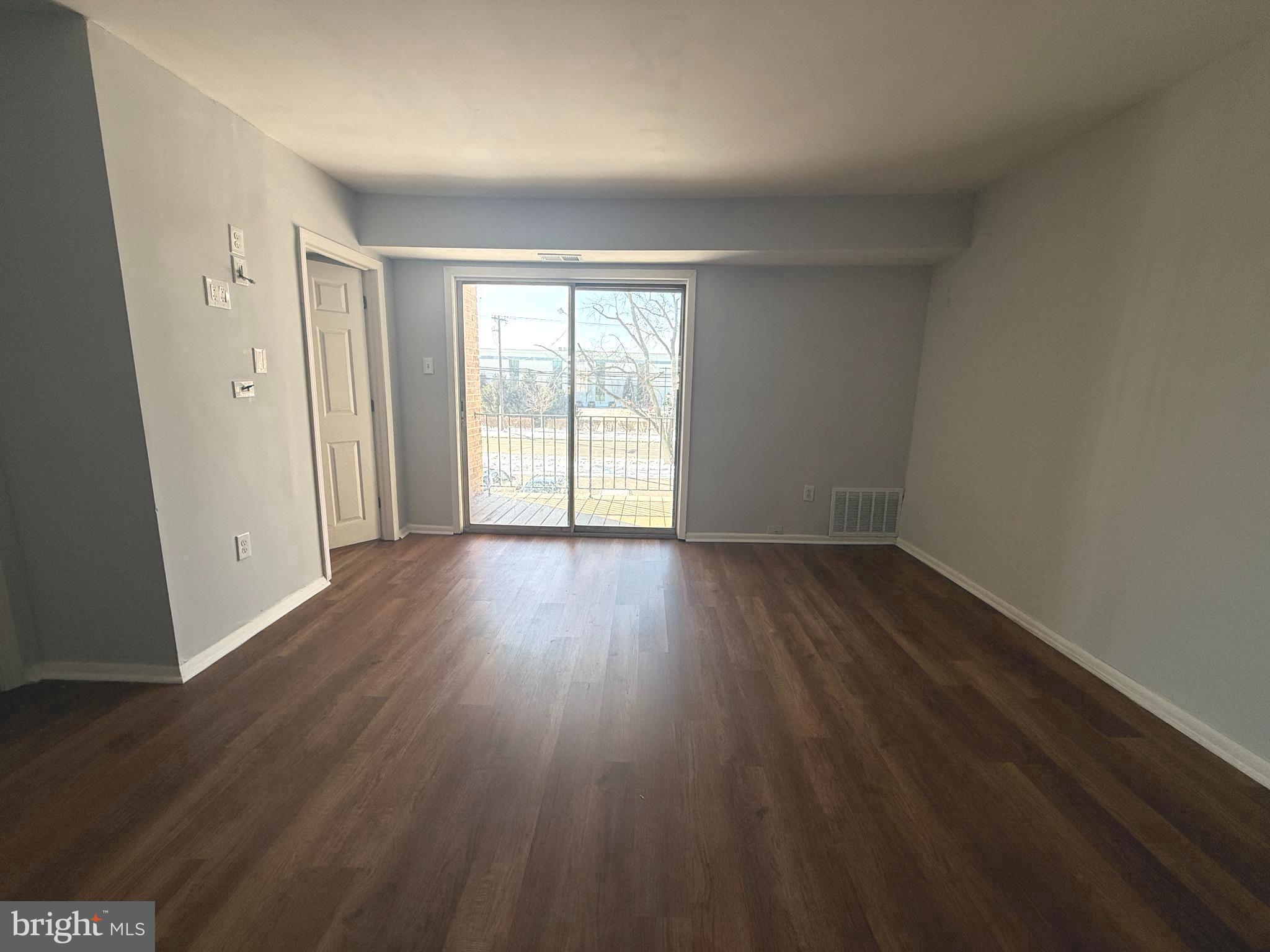 1294 Cooper Street, Unit A10 Edgewater Park, NJ 08010 - Photo 14 of 22 wooden floor in an empty room with a window
