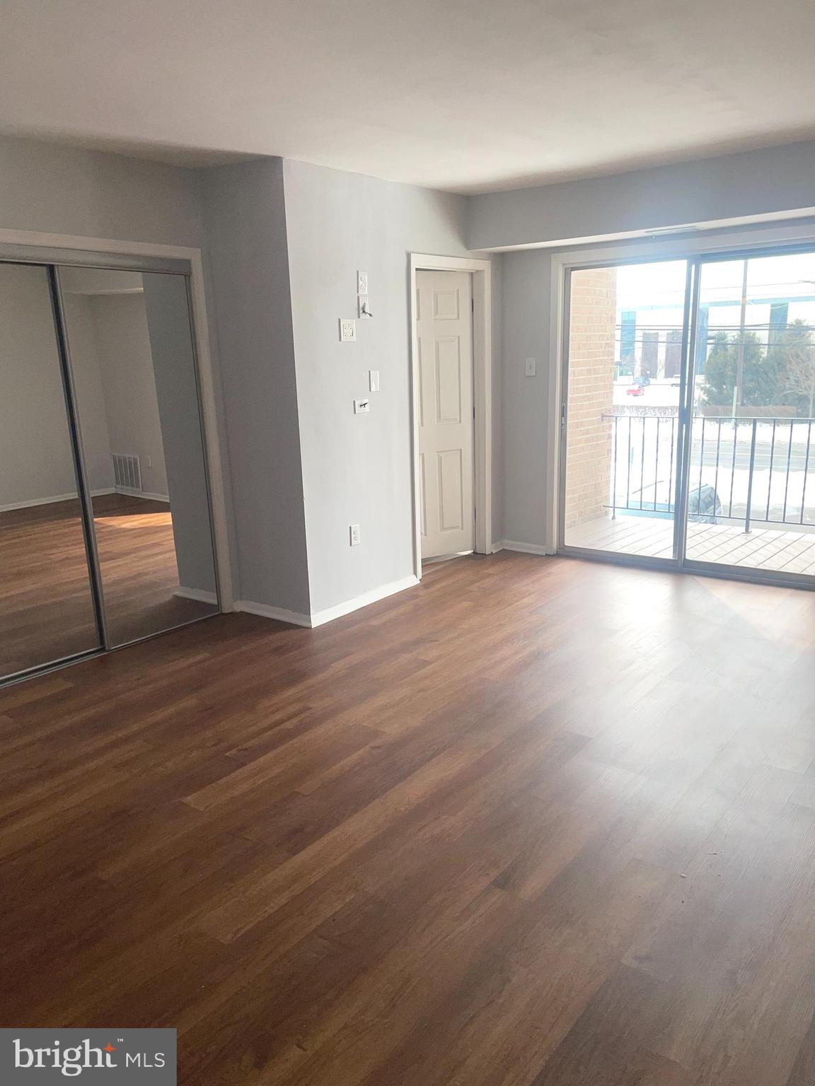 1294 Cooper Street, Unit A10 Edgewater Park, NJ 08010 - Photo 15 of 22 a view of an empty room with wooden floor and a window