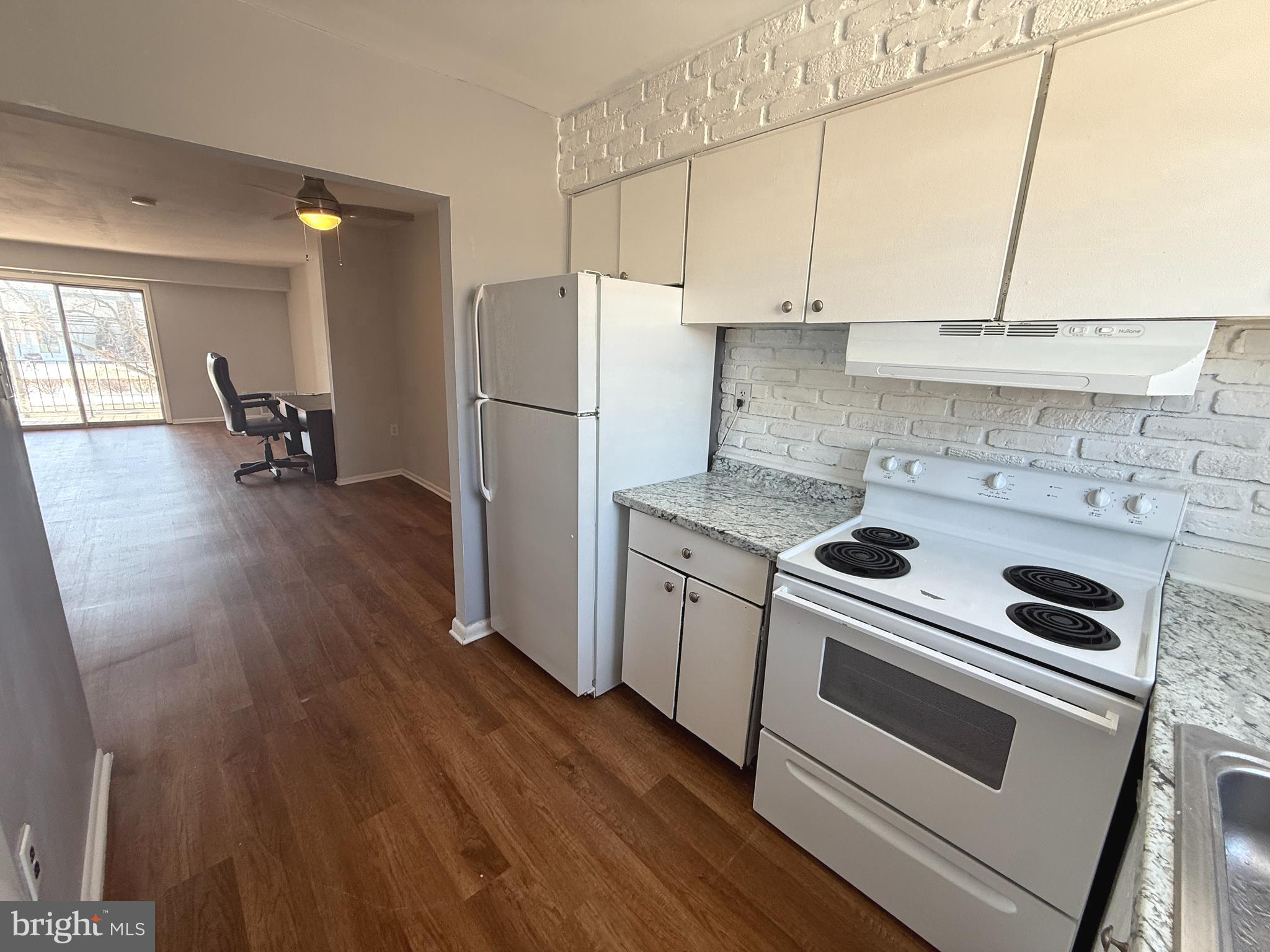 1294 Cooper Street, Unit A10 Edgewater Park, NJ 08010 - Photo 2 of 22 a kitchen with a stove a sink and a refrigerator