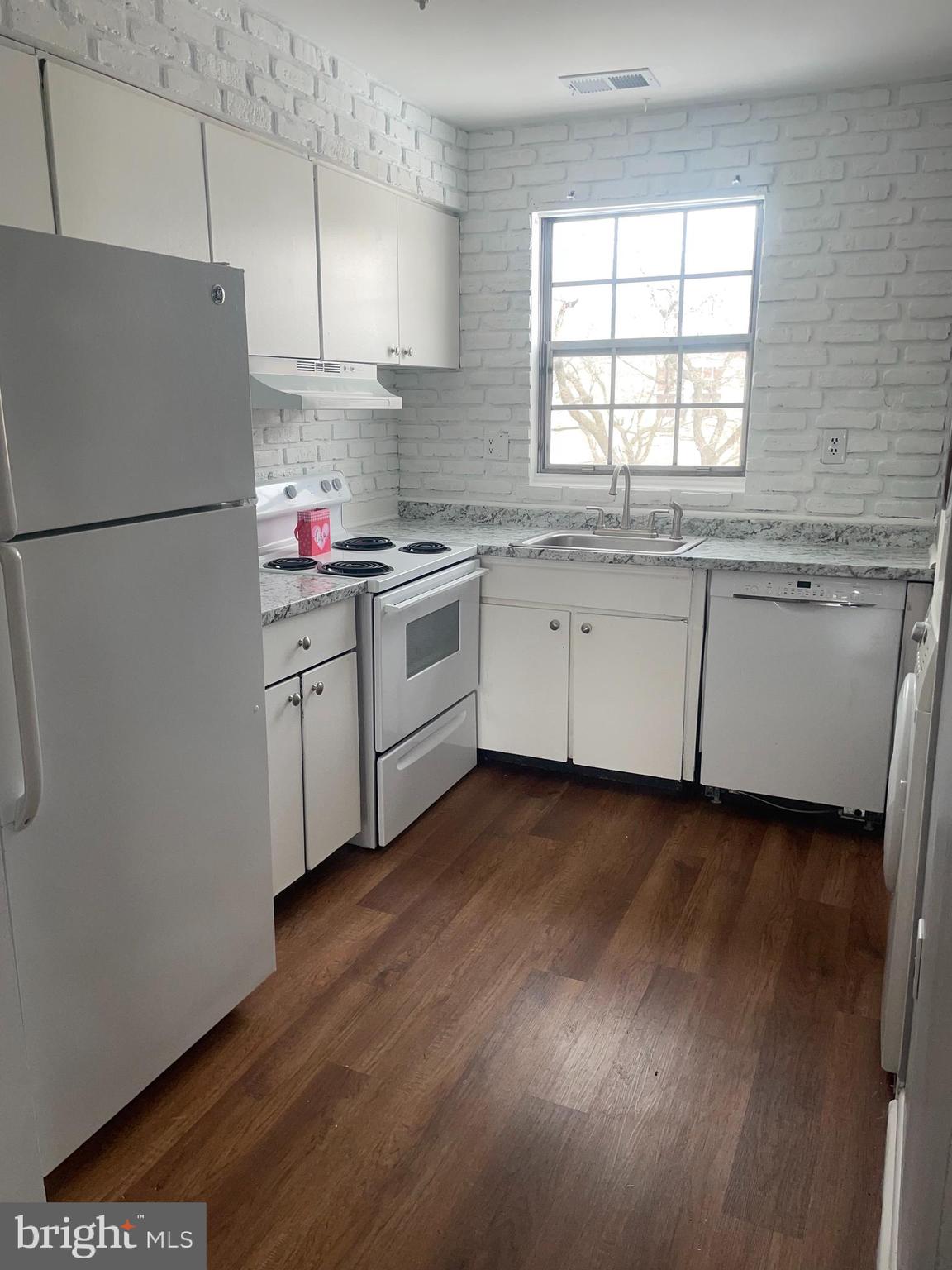 1294 Cooper Street, Unit A10 Edgewater Park, NJ 08010 - Photo 4 of 22 a kitchen with granite countertop white cabinets and white appliances