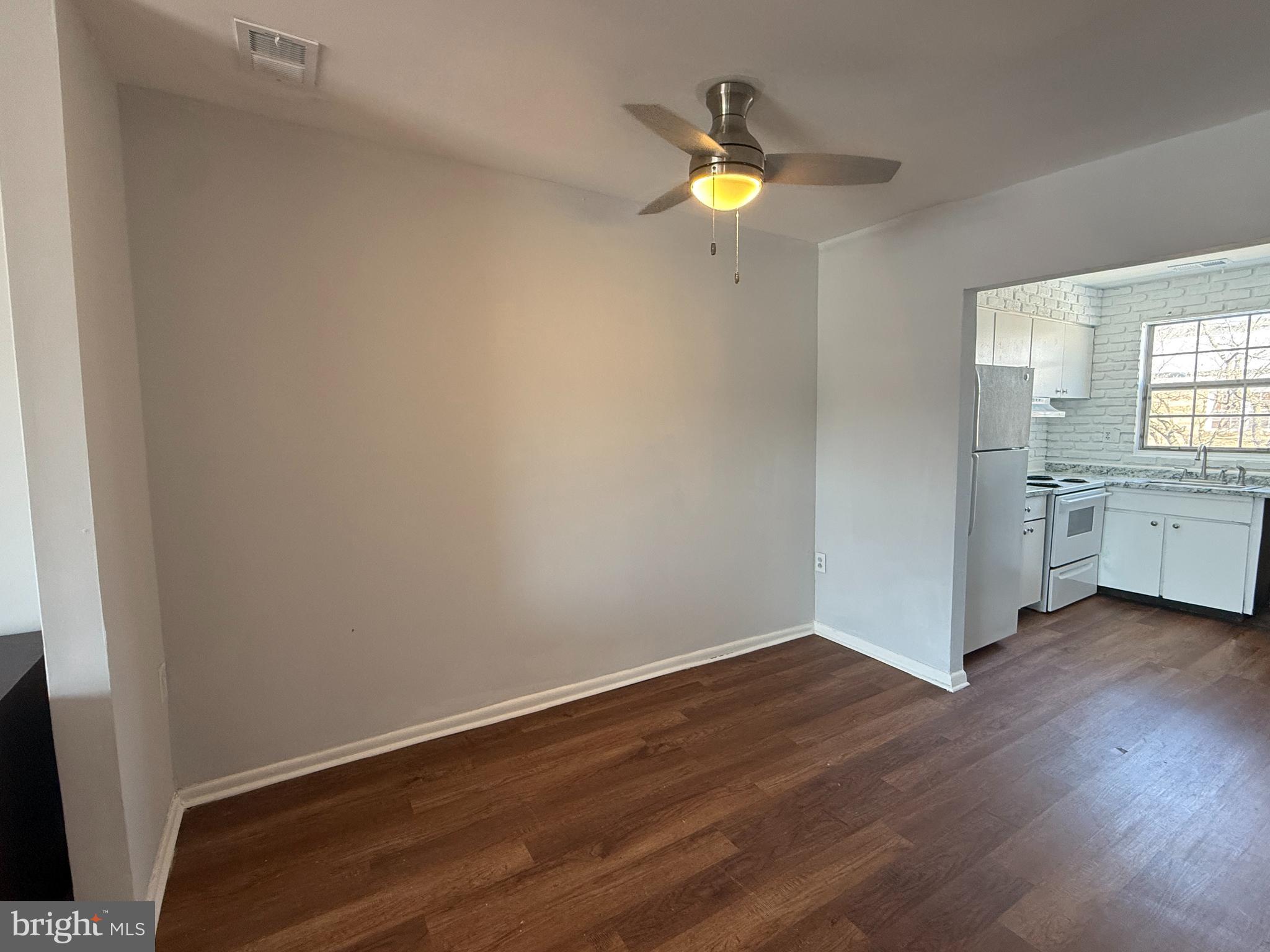 1294 Cooper Street, Unit A10 Edgewater Park, NJ 08010 - Photo 9 of 22 an empty room with wooden floor and windows