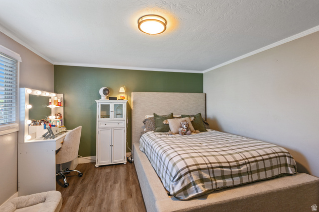 255 North 1600 West, Unit 60 Provo, UT 84601 - Photo 9 of 22 Bedroom featuring dark wood-style floors and crown molding