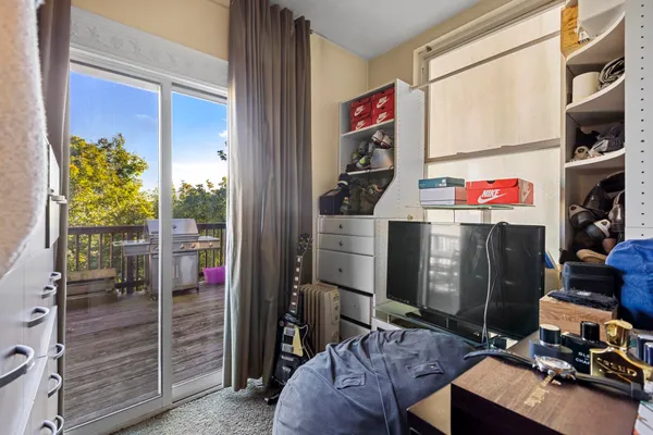 a view of a roof deck with table and chairs with wooden floor and fence