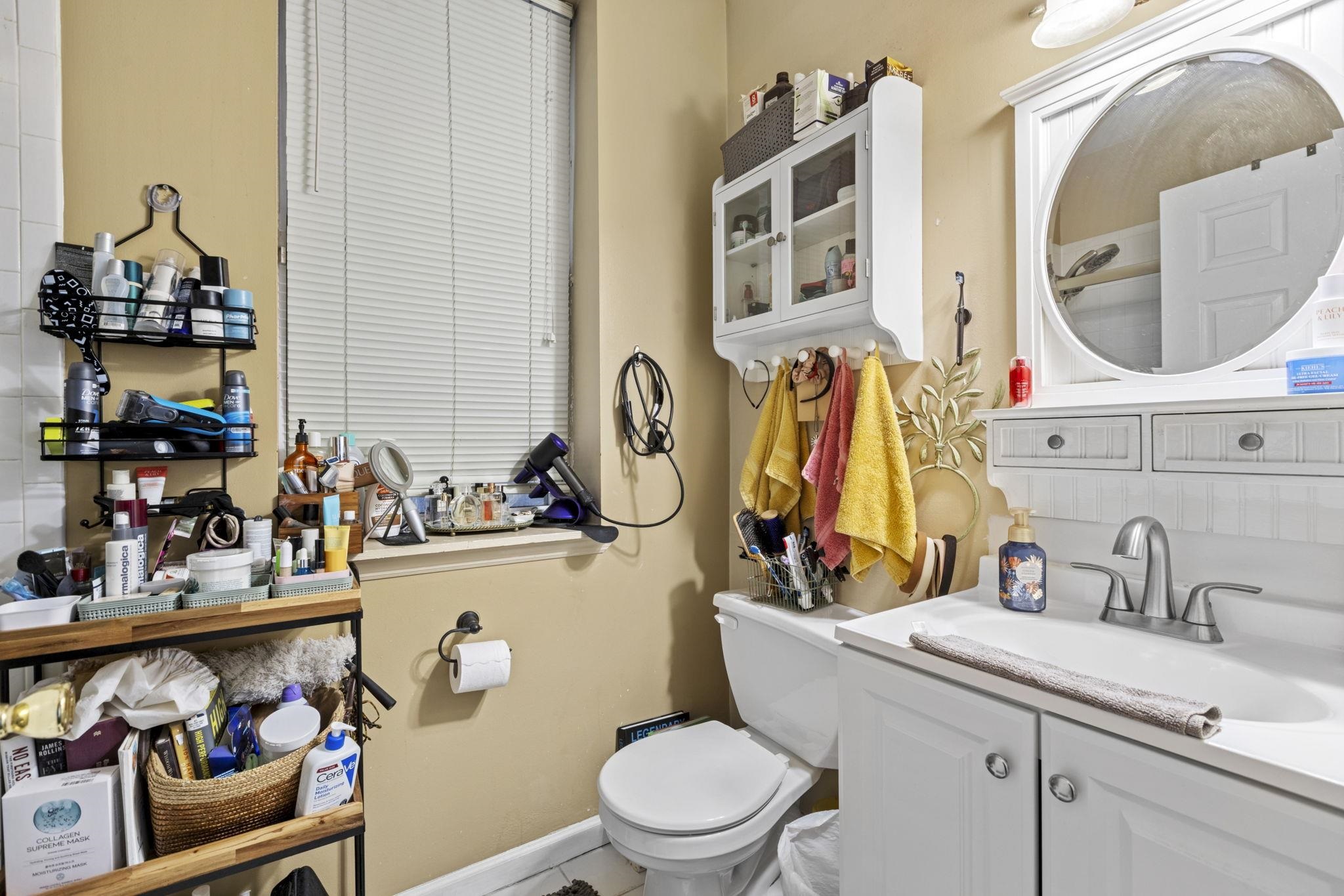 67 Highway 5 Edgewater, NJ 07020 - Photo 14 of 23 a bathroom with a sink mirror and toilet