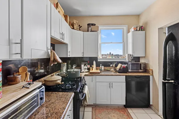 a kitchen with a sink stove and cabinets