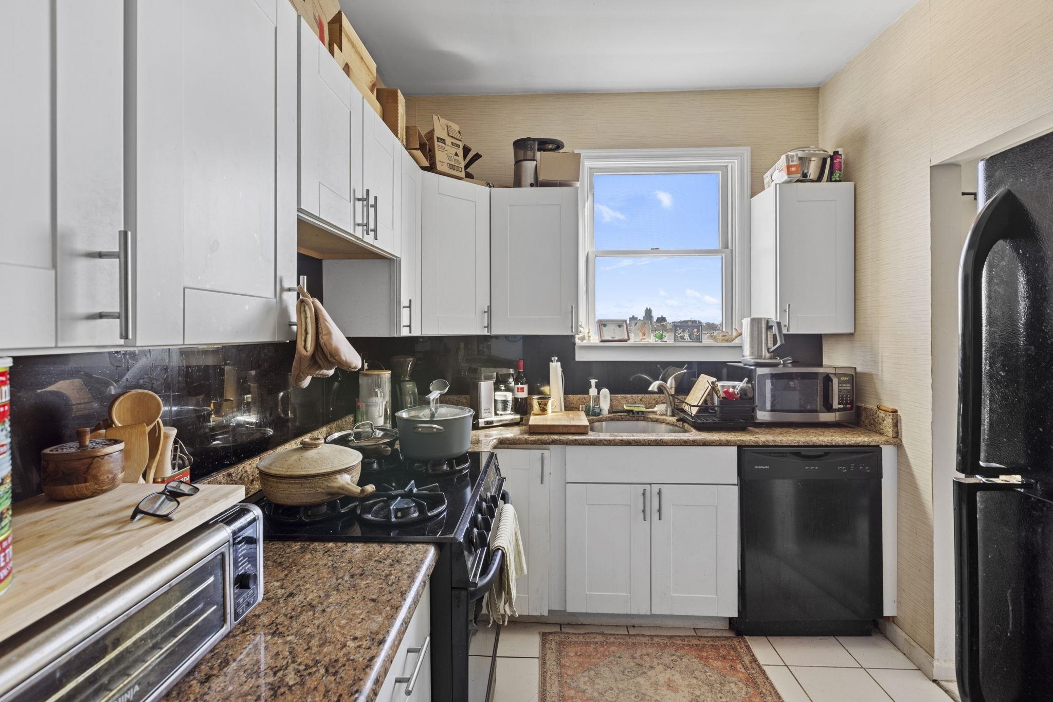 67 Highway 5 Edgewater, NJ 07020 - Photo 18 of 23 a kitchen with a sink stove and refrigerator