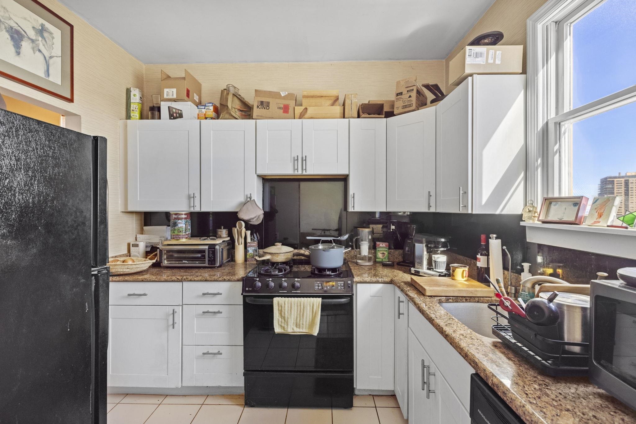 67 Highway 5 Edgewater, NJ 07020 - Photo 19 of 23 a kitchen with a sink stove and cabinets