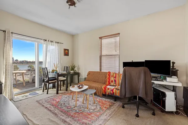 a bedroom with a bed and a large window