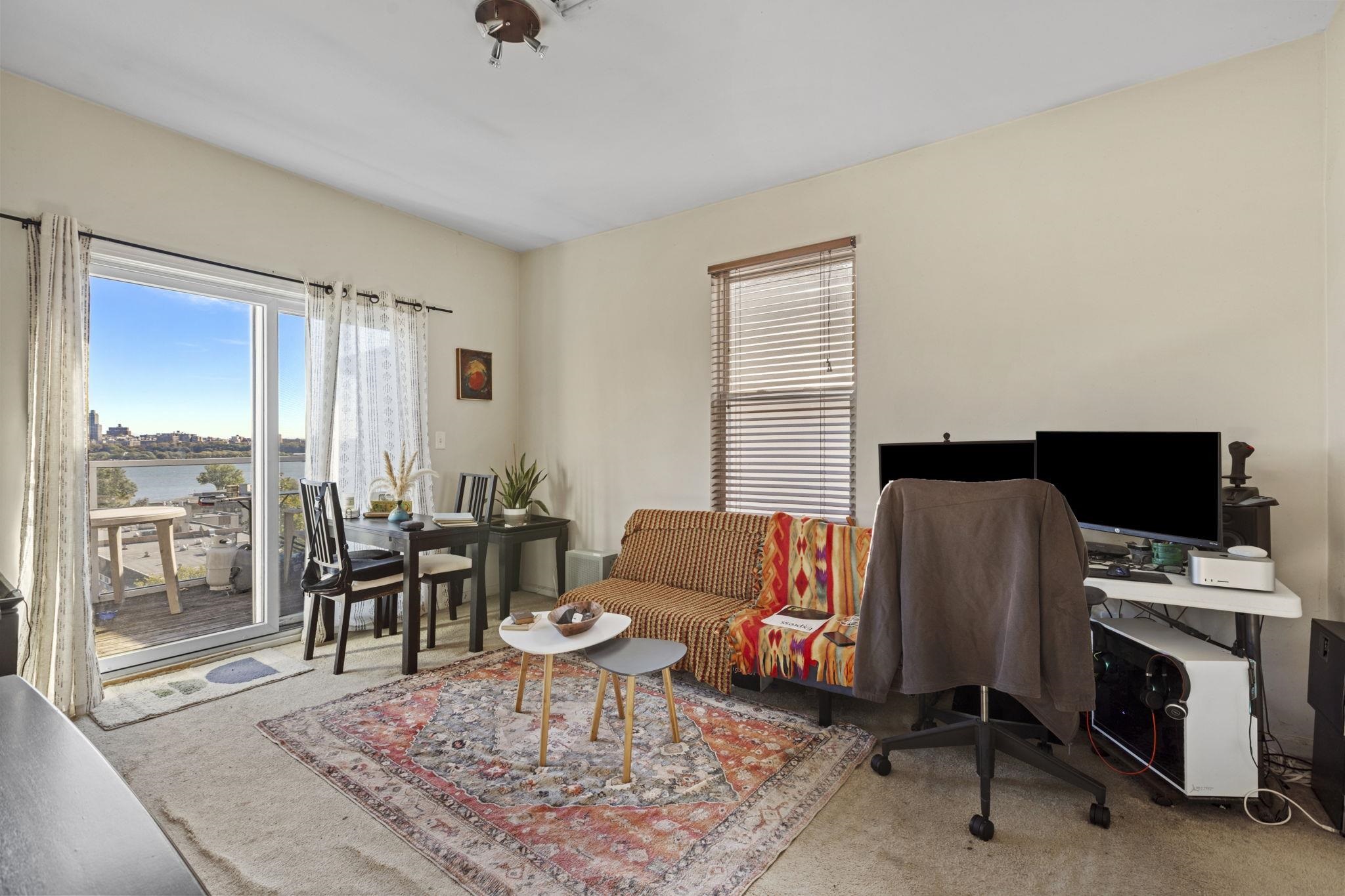 67 Highway 5 Edgewater, NJ 07020 - Photo 20 of 23 a living room with furniture and a flat screen tv