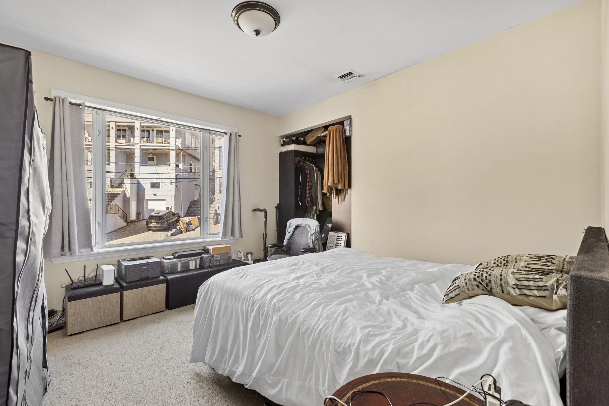 67 Highway 5 Edgewater, NJ 07020 - Photo 21 of 23 a bedroom with a bed and a large window