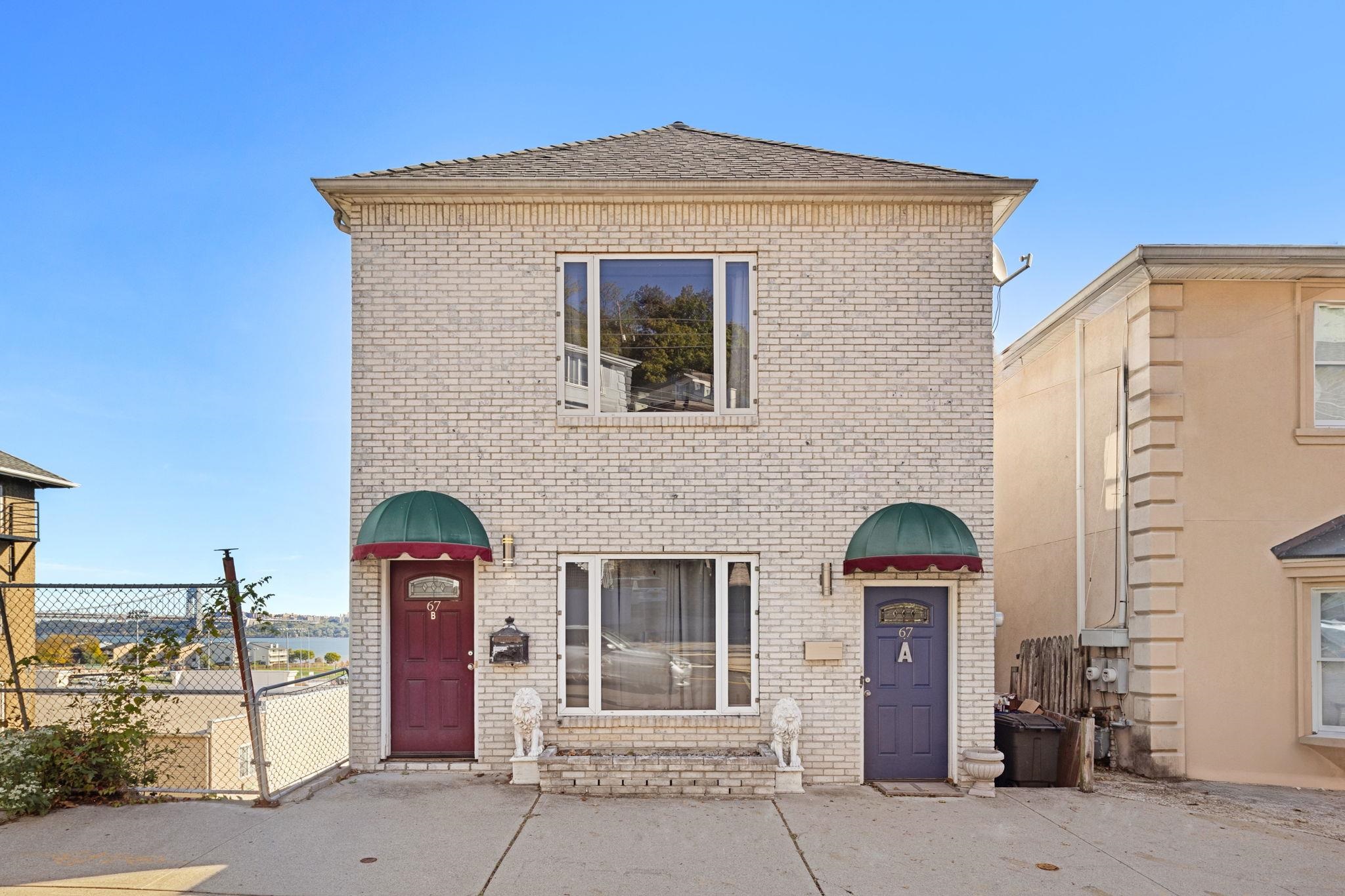 67 Highway 5 Edgewater, NJ 07020 - Photo 23 of 23 a front view of a house with garage