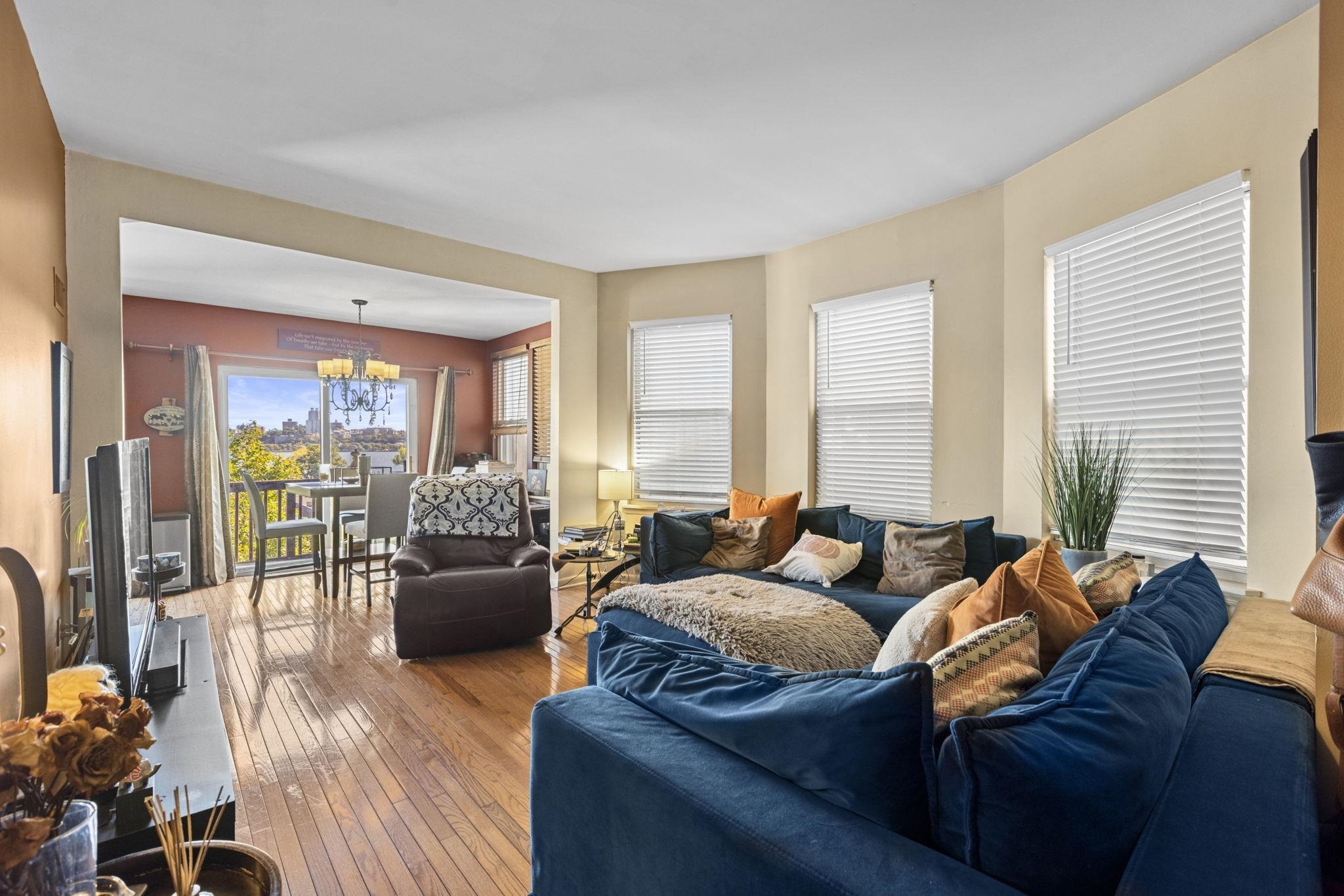 67 Highway 5 Edgewater, NJ 07020 - Photo 5 of 23 a living room with furniture and a large window