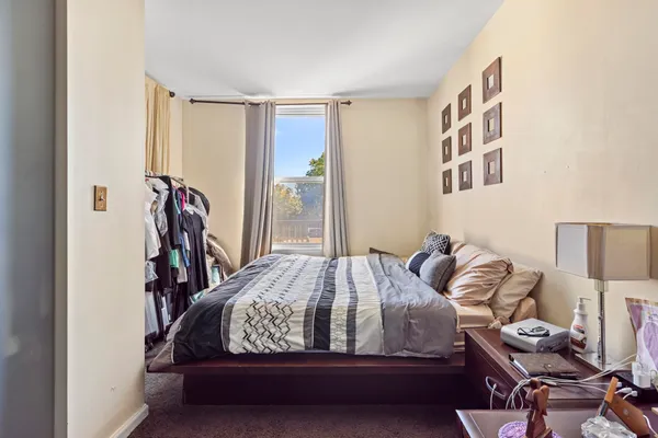 a bedroom with bed and a window