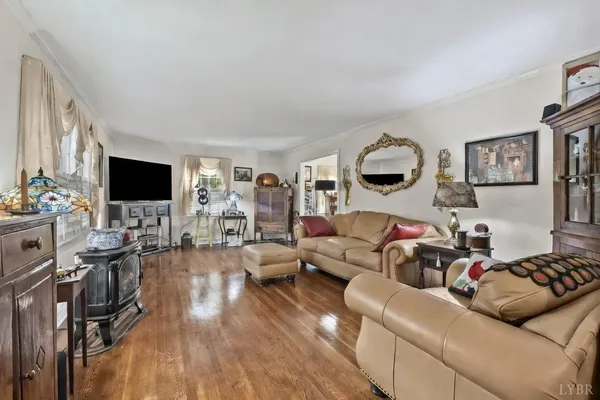 a living room with furniture flat screen tv and a fireplace