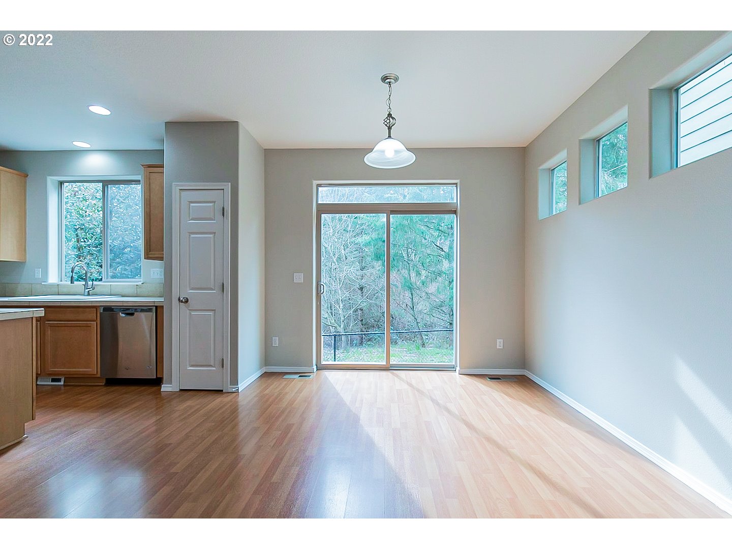 20008 Southwest Jette Lane Beaverton, OR 97003 - Photo 7 of 32 a view of an empty room with wooden floor and a window