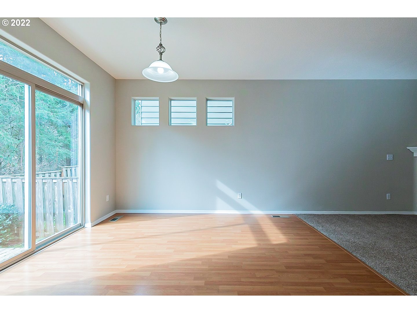 20008 Southwest Jette Lane Beaverton, OR 97003 - Photo 8 of 32 a view of an empty room with wooden floor and a window