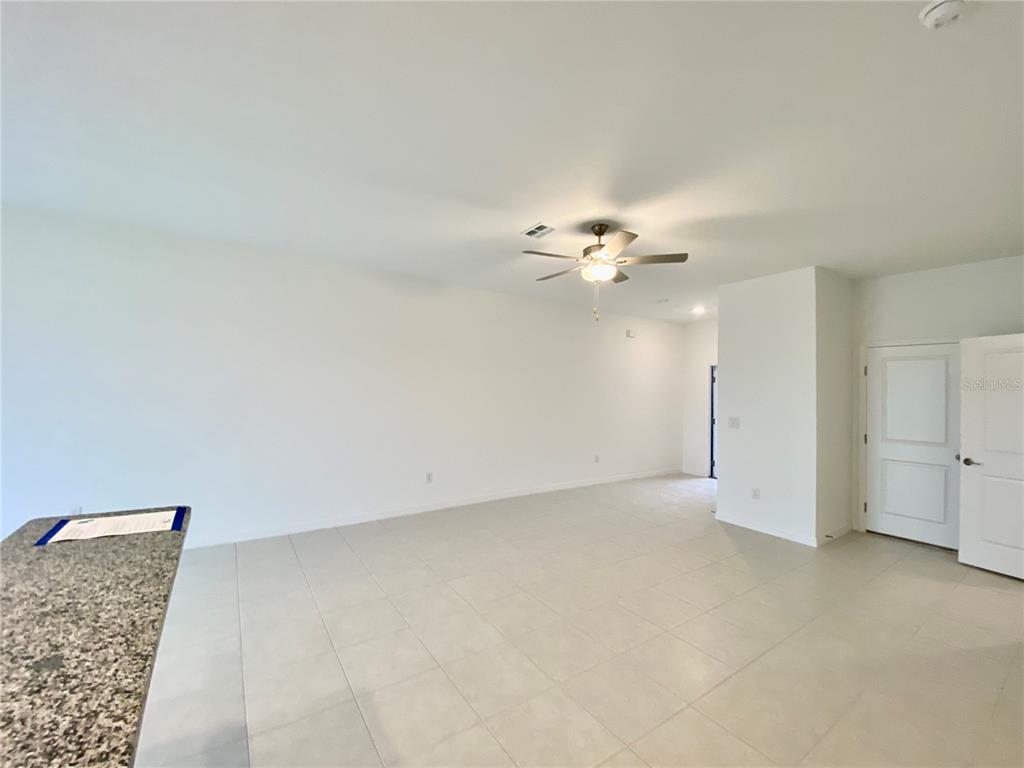 10373 Lavender Aster Trail San Antonio, FL 33576 - Photo 11 of 34 an empty room with a chandelier fan