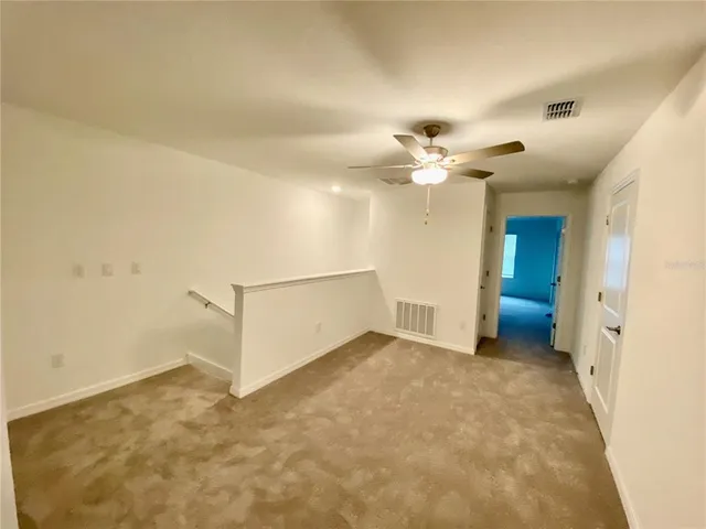 view of a big room with closet and chandelier fan