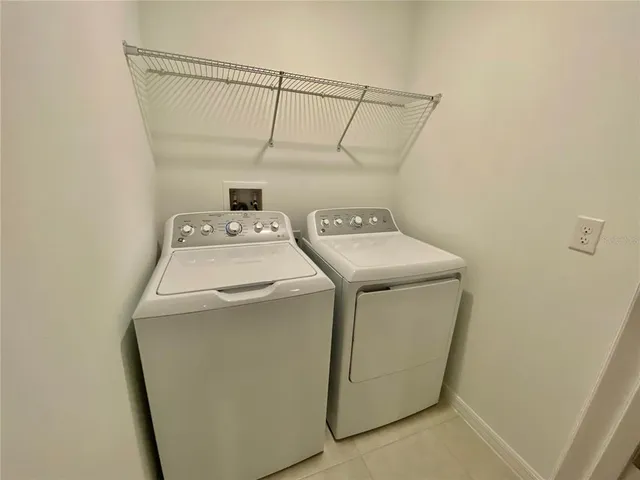 an empty room with closet and fan