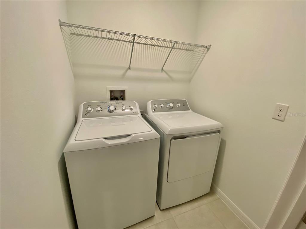 10373 Lavender Aster Trail San Antonio, FL 33576 - Photo 16 of 34 a utility room with dryer and washer