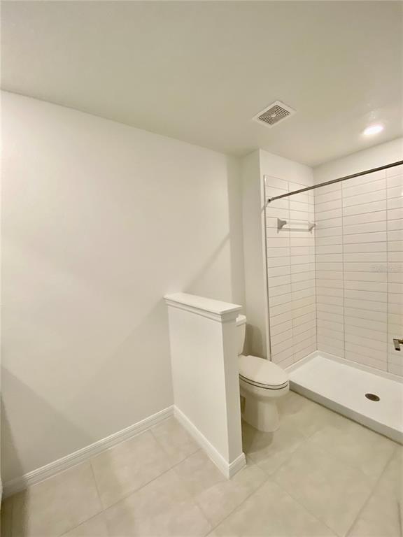 10373 Lavender Aster Trail San Antonio, FL 33576 - Photo 22 of 34 a bathroom with a toilet and shower