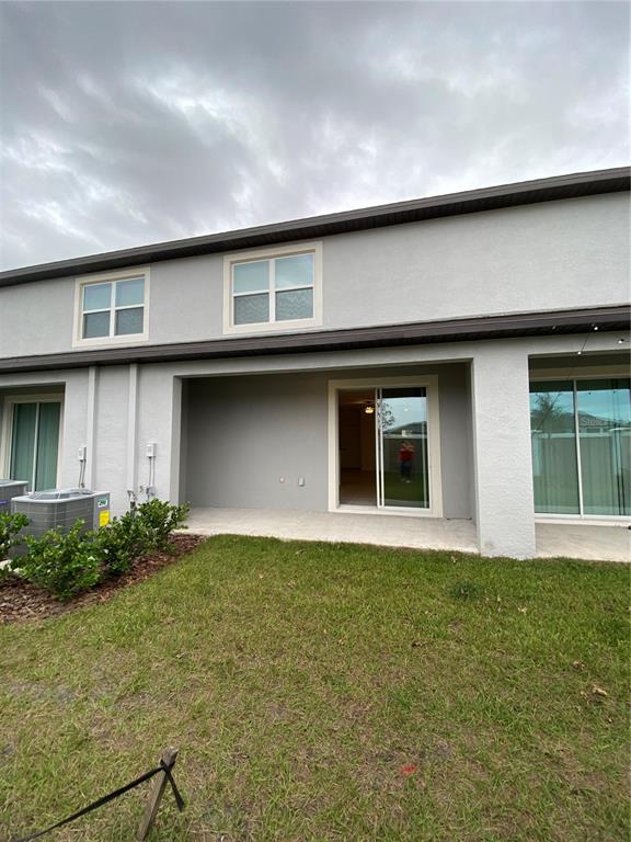 10373 Lavender Aster Trail San Antonio, FL 33576 - Photo 24 of 34 a front view of brick house with a yard