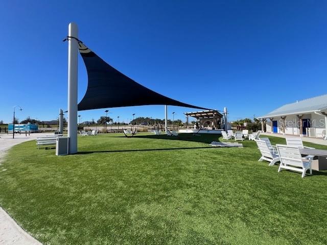 10373 Lavender Aster Trail San Antonio, FL 33576 - Photo 28 of 34 a backyard of a house with table and chairs