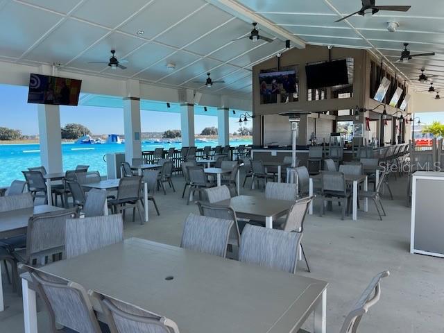 10373 Lavender Aster Trail San Antonio, FL 33576 - Photo 31 of 34 a dining room with lots of tables a large window and chairs