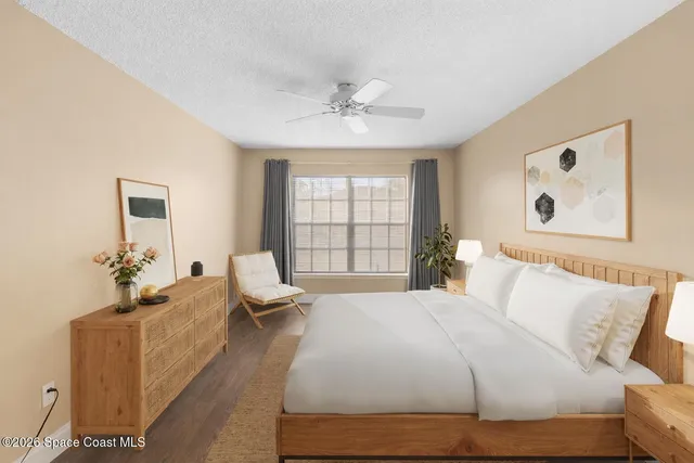 a bedroom with a bed and glass window