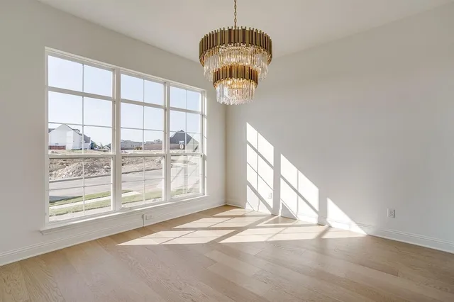 a view of a room with wooden floor and windows