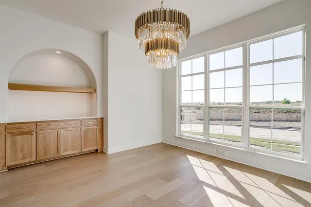 a very nice looking room with a large window and chandelier