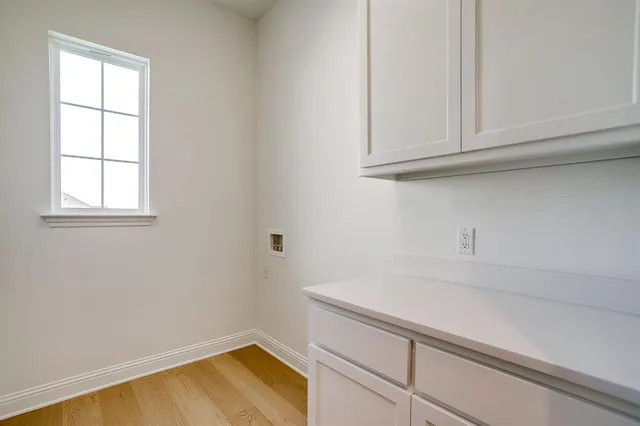a view of storage and utility room with window