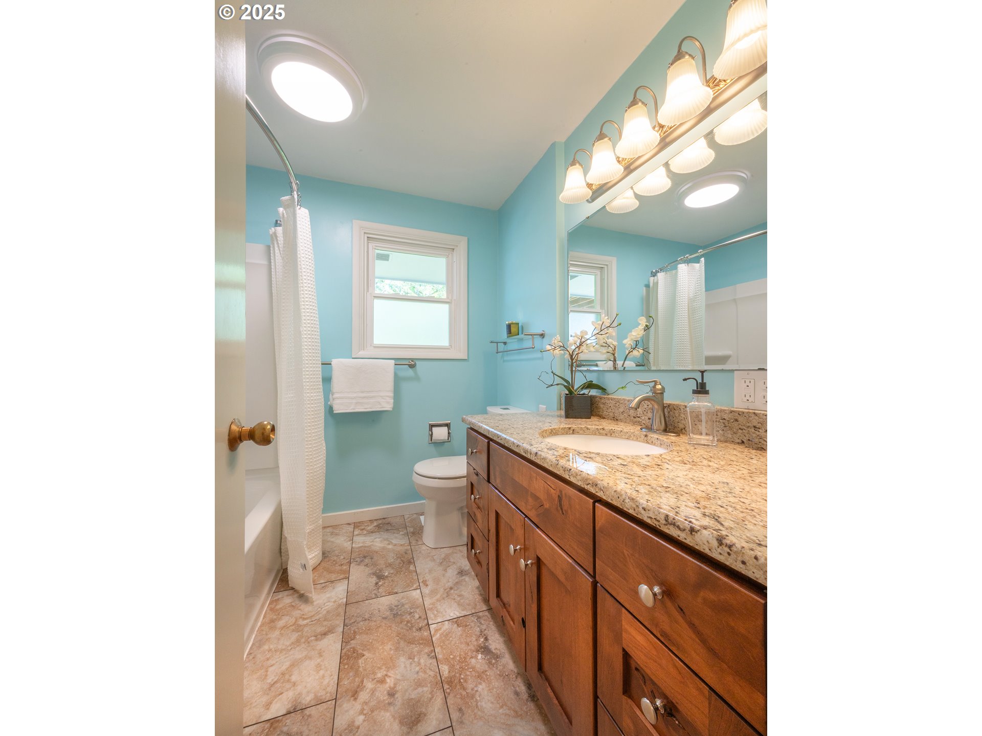 464 Spring Creek Drive Eugene, OR 97404 - Photo 12 of 45 a bathroom with a granite countertop sink a toilet and a mirror