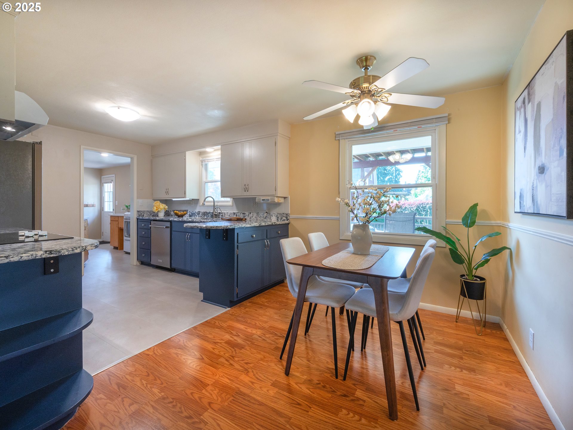 464 Spring Creek Drive Eugene, OR 97404 - Photo 13 of 45 a view of a dining room with furniture a chandelier and wooden floor