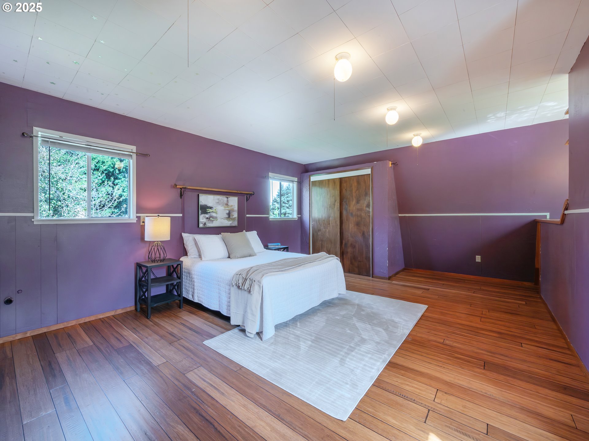 464 Spring Creek Drive Eugene, OR 97404 - Photo 30 of 45 a spacious bedroom with a bed and wooden floor