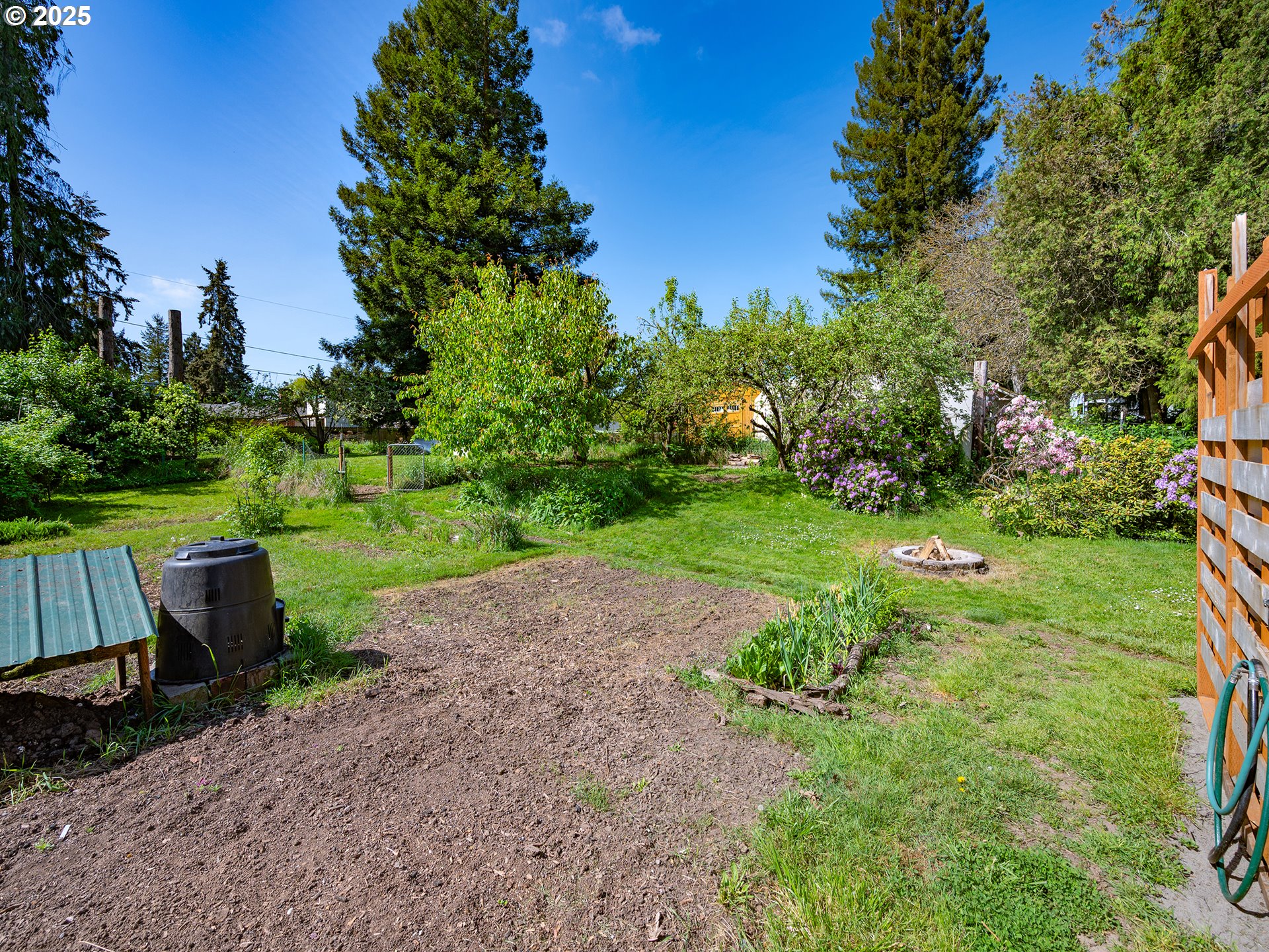 464 Spring Creek Drive Eugene, OR 97404 - Photo 39 of 45 a view of a garden with plants and a bench