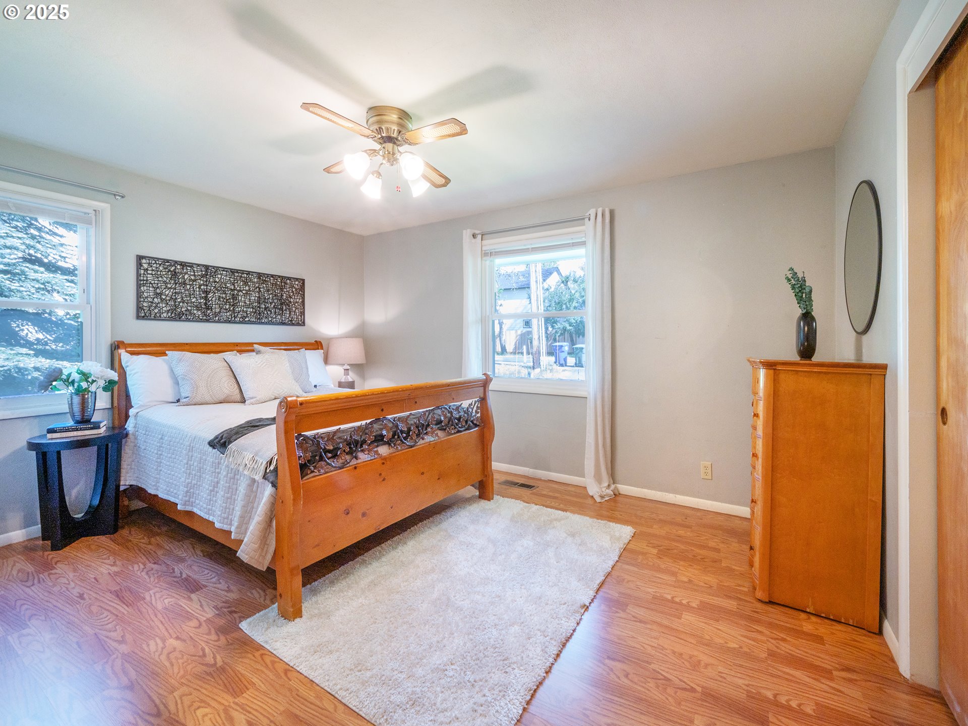 464 Spring Creek Drive Eugene, OR 97404 - Photo 10 of 45 a bedroom with a bed and a chandelier