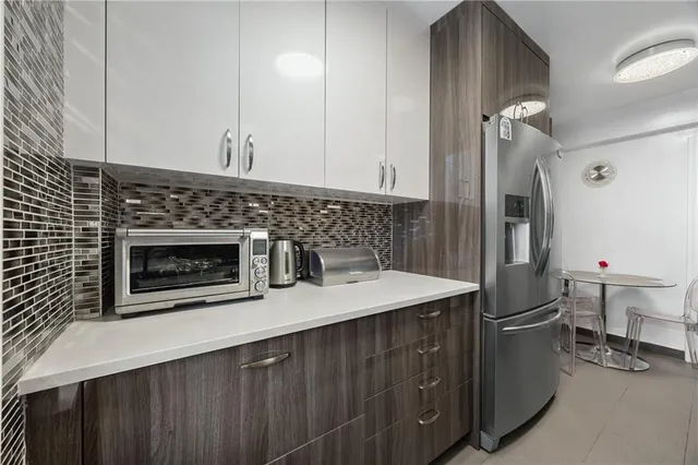 a kitchen with a sink and a refrigerator
