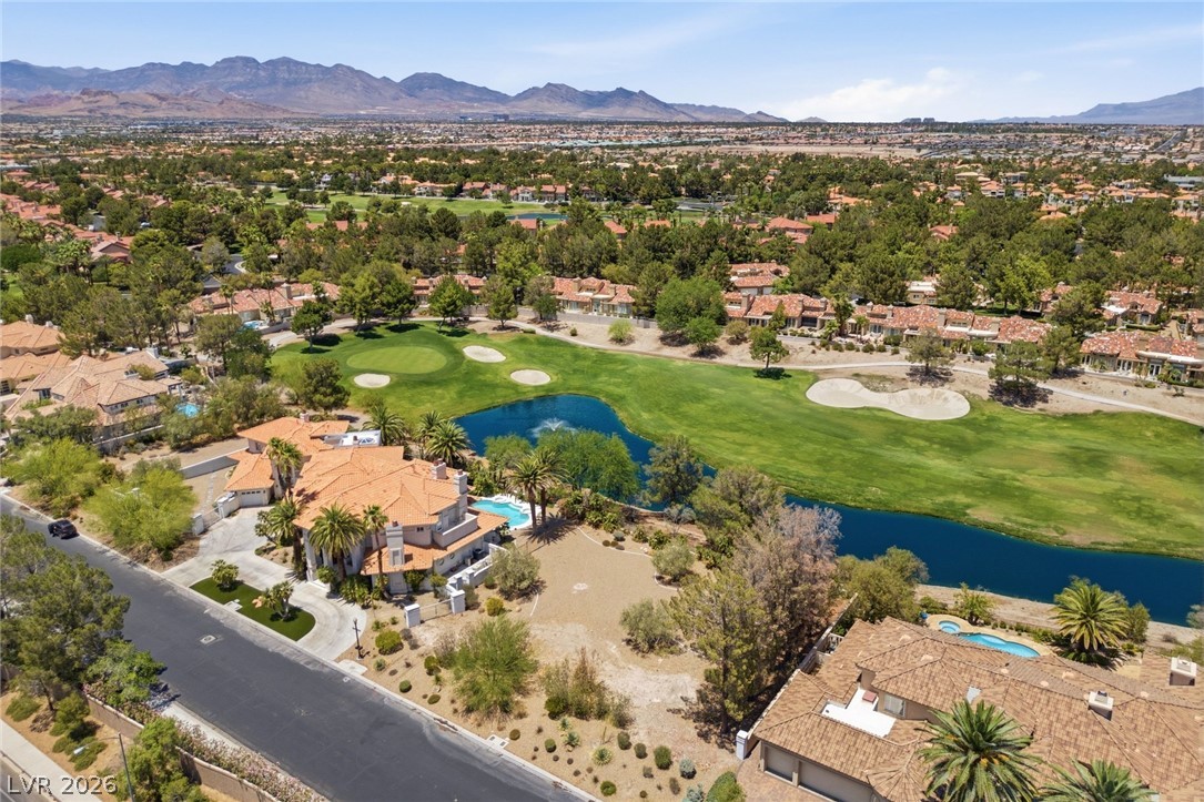 20 Innisbrook Avenue Las Vegas, NV 89113 - Photo 4 of 39 Overlook the golf course from this elegant residence, offering tranquil water features and a verdant setting.