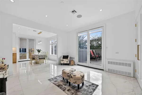 a living room with furniture large window and glass door