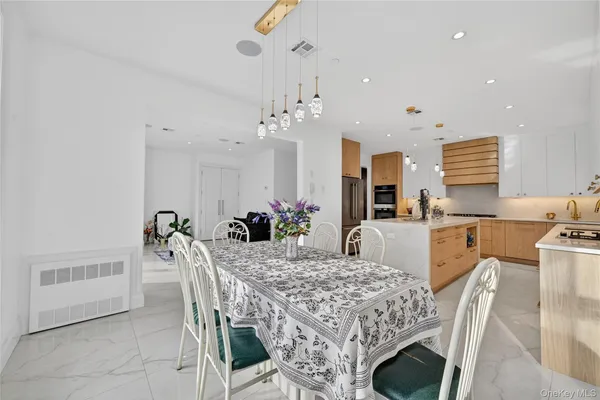 a view of a dining room with furniture and a chandelier