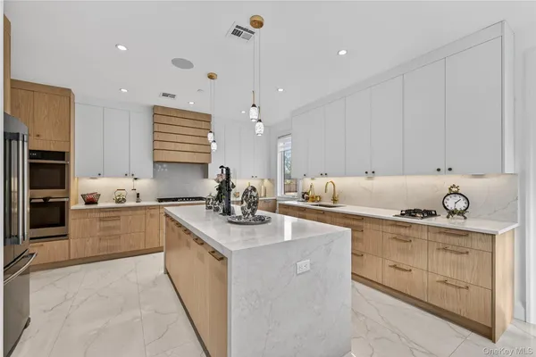 a kitchen with stainless steel appliances granite countertop a sink a stove and a refrigerator