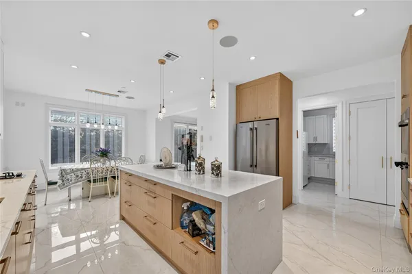 a large white kitchen with a large window
