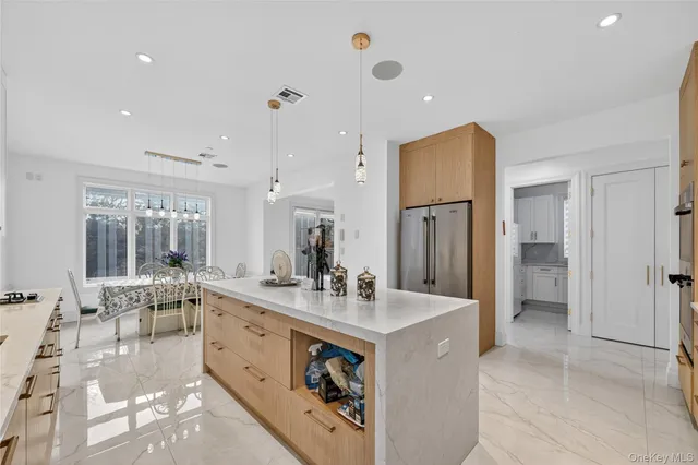 a large white kitchen with a large window