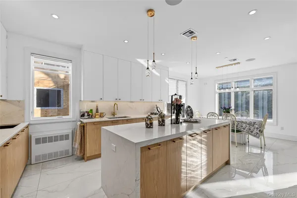 a kitchen with stainless steel appliances a sink stove and cabinets